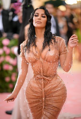 Image may contain Kim Kardashian Adult Person Clothing Swimwear Bathing Black Hair Hair Dress Footwear and Shoe