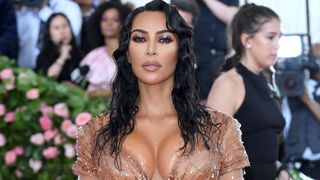 Image may contain Kim Kardashian Fashion Clothing Footwear High Heel Shoe Person Adult Black Hair Hair and Dress Met Gala