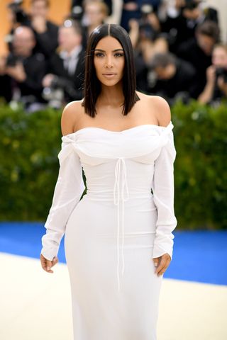 Image may contain Kim Kardashian La Parka Adult Person Black Hair Hair Fashion Clothing Dress Formal Wear and Gown